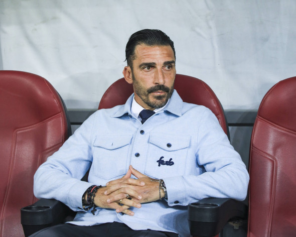 Coach Elias Charalambous on the bench before the start of the game